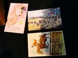 three cards on a table with a picture of a woman riding a horse