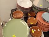 a lot of plates and bowls on the table