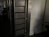 a tall metal cabinet in the middle of a dark room