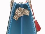 the small blue purse has a bow on the handle