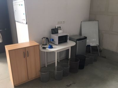 a small table with a microwave and a refrigerator in a room