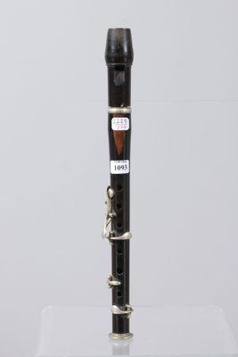 a close up of a clarinet on a clear surface with a white background