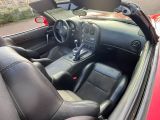 a red sports car with black leather seats and dashboard