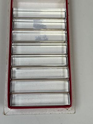 a red and white tray with a bunch of metal items in it
