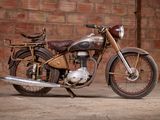 a motorcycle that is parked in front of a brick wall