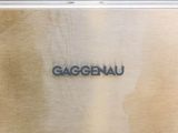a close up of a metal plate with the word gaggenau written on it