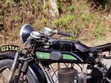 a black and green motorcycle parked on the side of the road
