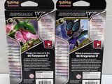 two packs of pokemon trading cards on a white surface