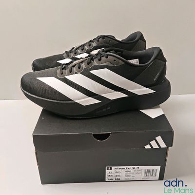 the black and white adidas shoes are on top of a box