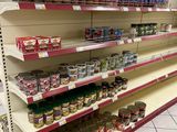 many shelves with canned food on them in a store