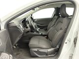 the interior of a car with the door open and the driver ' s seat down