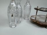 three vases and a tray on a table