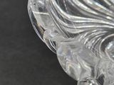 a clear glass bowl with a decorative design on it