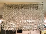 a large chandelier hanging from the ceiling in a kitchen