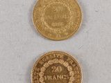 two gold coins, one of which has a crown and the other of which has a crown on it