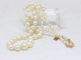 pearl necklace with a gold clasp and a white pearl bead