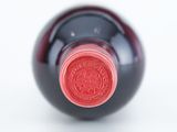 a close up of a wine bottle with a red label