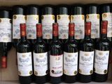 many bottles of wine in a box on the shelf