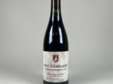 the bottle of red wine is sitting on the table