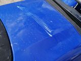 a blue motorcycle parked on the side of the road