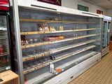 a large display case in the middle of a grocery store