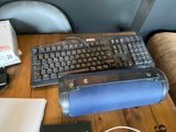 a computer keyboard and mouse on a wooden table