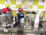 a kitchen counter with a mixer, blender, and other appliances
