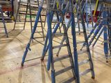 many ladders that are sitting in a room