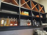 de nombreuses bouteilles et verres sur les étagères de la cuisine
