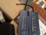 a box of electronics and a bag of items on the floor