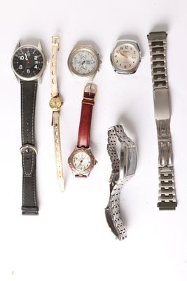 a lot of watches that are laying out on the table
