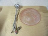 a bowl and a spoon on a table next to a glass