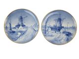 pair of blue and white plates with ships and windmills