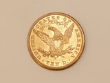 a close up of a gold coin with an eagle on it