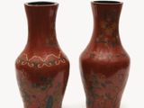 two vases sitting side by side on a white surface