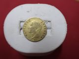 an image of a gold coin on a red surface