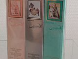 two boxes of perfume sitting on top of a glass table