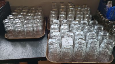 a lot of empty glasses sitting on a table