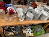 a wooden table with a lot of dishes and cups on it