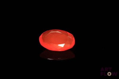 an image of a glowing red stone on a black surface