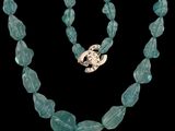 an image of a necklace with a turtle on a black background