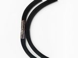 a close up of a pair of black hoses on a white surface