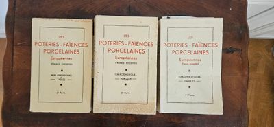 three books that are sitting on top of a wooden table