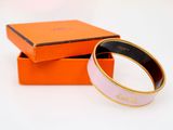 a close up of a bracelet in a box on a white surface