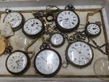 a box with a bunch of pocket watches inside of it