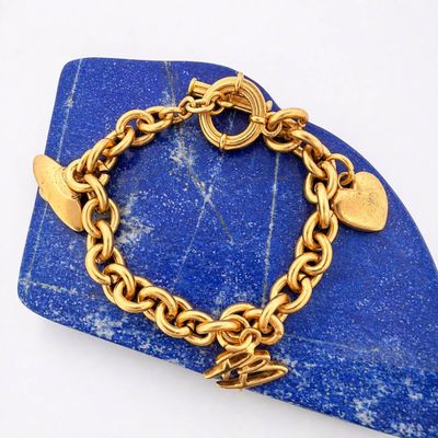 an image of a gold bracelet with a heart charm on it