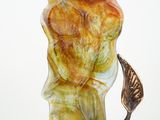 a glass sculpture of a bird on a branch