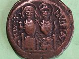 a close up of a coin on a table with a green background