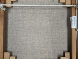 a close up of a wooden frame with a rope on it