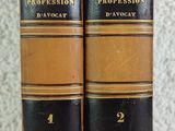 two old books sitting on top of a table next to each other